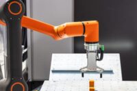 Robotic pick and place machine reaching for an item to move